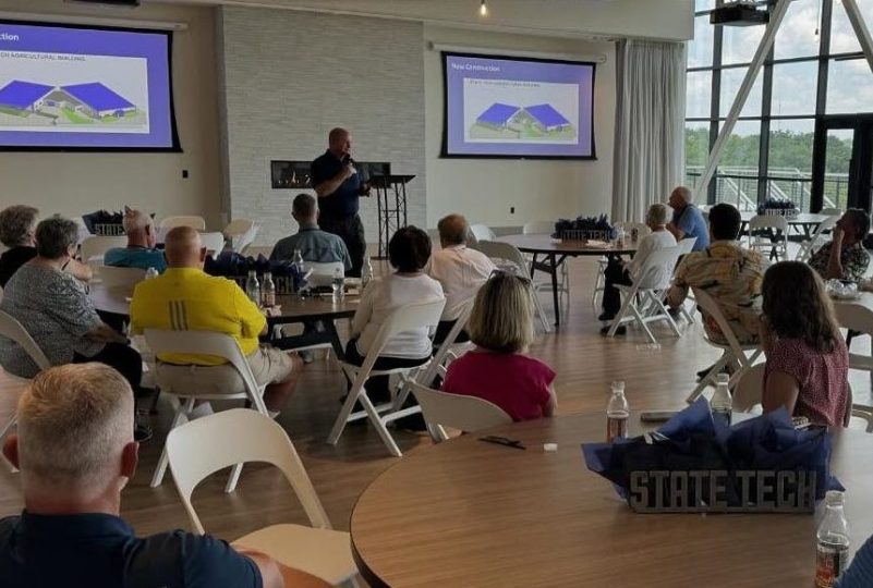 people seated listening to a presentation
