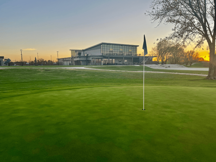 golf course with flag and clubhouse